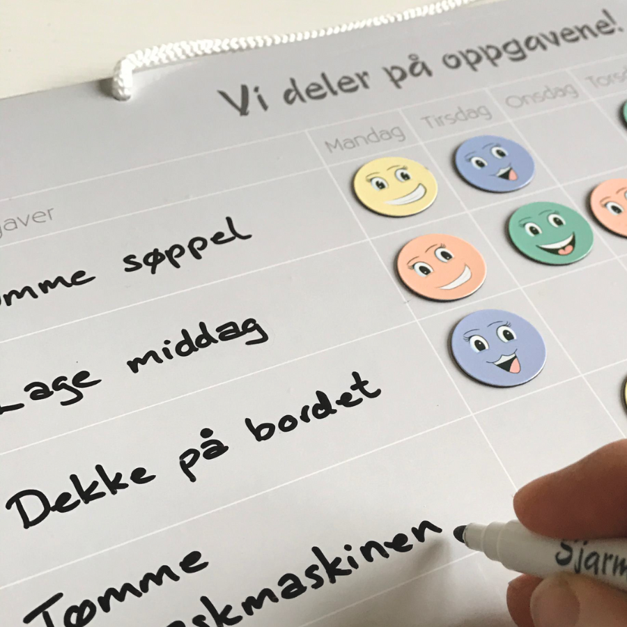 Nærbilde av en kalender som beskriver hverdagslige oppgaver som skal fordeles til familien.